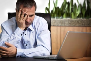 Frustrated Account Manager at laptop. Frustrated Account Manager at laptop.